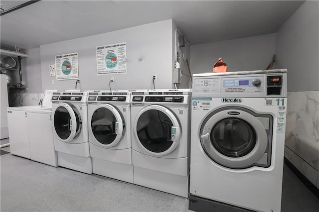 community laundry featuring separate washer and dryer
