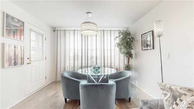 living area featuring wood finished floors and a chandelier