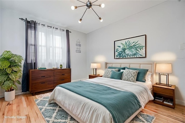 2807 Kings Hwy Unit 4C, Brooklyn, NY 11229 - bedroom featuring a chandelier, hardwood / wood-style floors, and baseboards