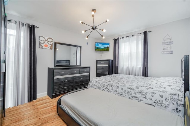 2807 Kings Hwy Unit 4C, Brooklyn, NY 11229 - bedroom featuring a chandelier, light wood-style flooring, and baseboards