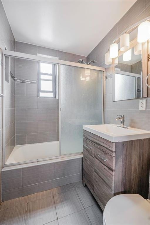 2807 Kings Hwy Unit 4C, Brooklyn, NY 11229 - full bath featuring tiled shower / bath, vanity, tile patterned floors, and toilet