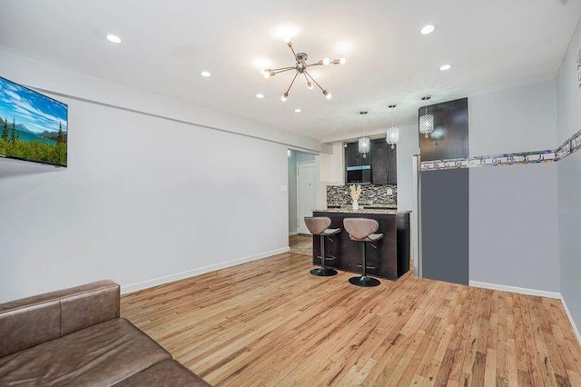2807 Kings Hwy Unit 4C, Brooklyn, NY 11229 - living room with a chandelier, recessed lighting, light wood-style flooring, and baseboards