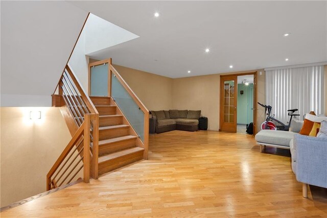 2556 E 26th St, Brooklyn, NY 11235 - living area featuring light wood finished floors, stairs, and recessed lighting