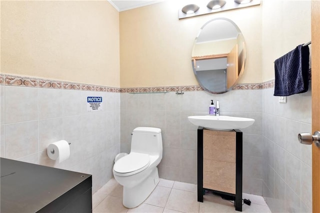 2556 E 26th St, Brooklyn, NY 11235 - half bath with crown molding, tile patterned flooring, a wainscoted wall, and tile walls