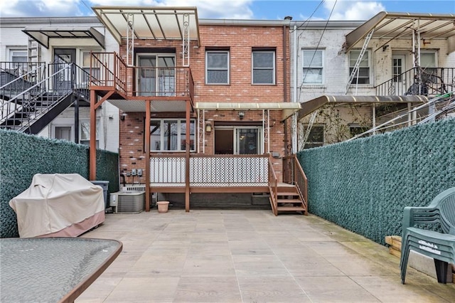 2556 E 26th St, Brooklyn, NY 11235 - back of house with brick siding, central AC, and a patio