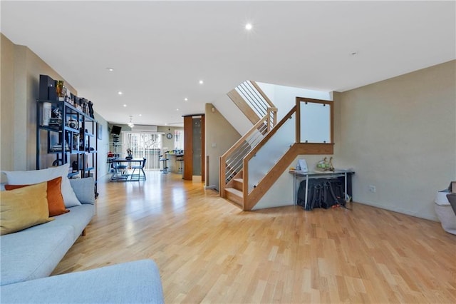 2556 E 26th St, Brooklyn, NY 11235 - living room with stairs, wood finished floors, recessed lighting, and baseboards