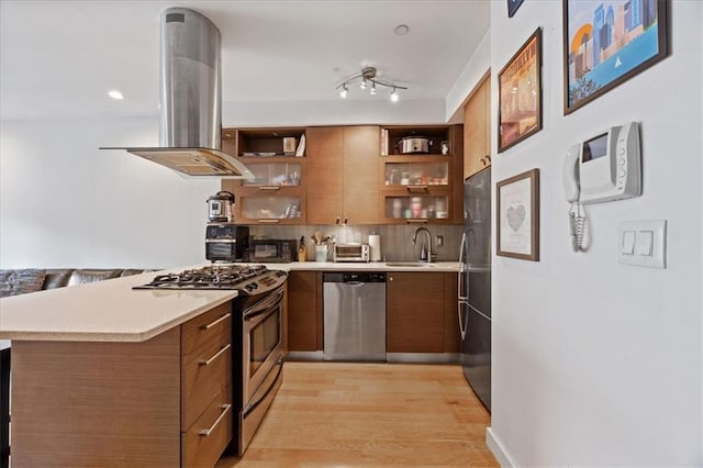 282 21st St Unit 2C, Brooklyn, NY 11215 - kitchen featuring stainless steel appliances, brown cabinets, island exhaust hood, and open shelves