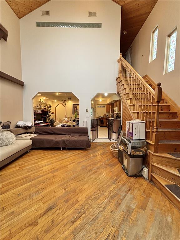 456 Oder Ave, Staten Island, NY 10304 - living area featuring high vaulted ceiling, hardwood / wood-style floors, wood ceiling, arched walkways, and stairway