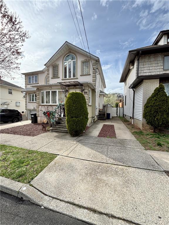 traditional-style house with concrete driveway