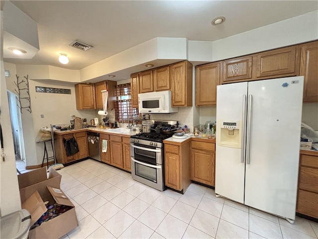 456 Oder Ave, Staten Island, NY 10304 - kitchen featuring stainless steel appliances, brown cabinets, light tile patterned floors, and light countertops