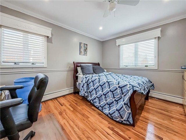 bedroom with a baseboard radiator, ornamental molding, and multiple windows