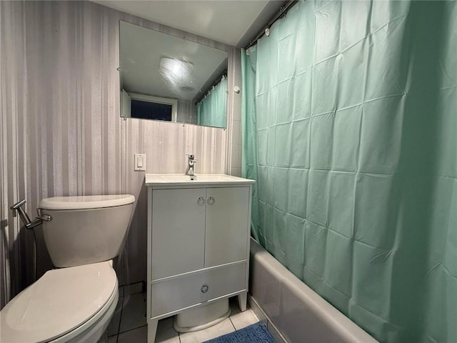 full bath featuring toilet, vanity, tile patterned flooring, and shower / tub combo with curtain