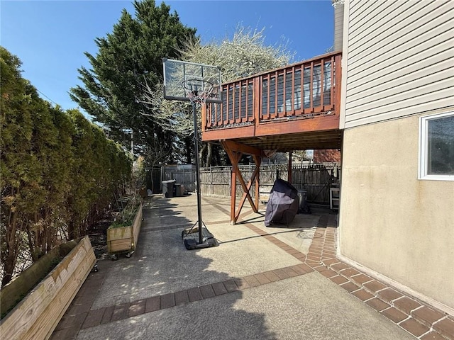 view of patio with a fenced backyard and a wooden deck
