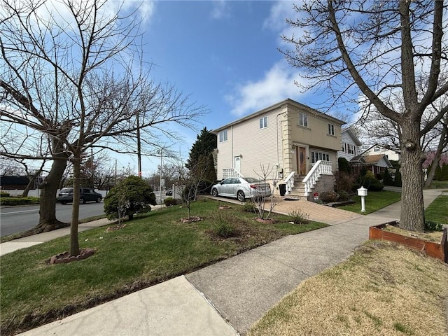 view of property exterior with a yard and concrete driveway