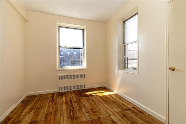 50 Kenilworth Pl Unit 5M, Brooklyn, NY 11210 - spare room featuring radiator, healthy amount of natural light, and hardwood / wood-style flooring