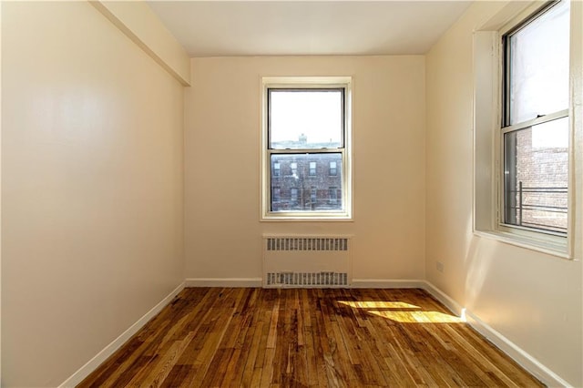 50 Kenilworth Pl Unit 5M, Brooklyn, NY 11210 - empty room with radiator heating unit and hardwood / wood-style flooring