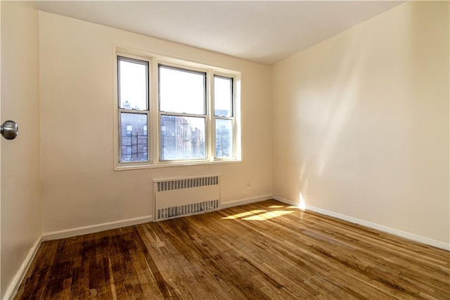 50 Kenilworth Pl Unit 5M, Brooklyn, NY 11210 - spare room featuring radiator heating unit and wood finished floors