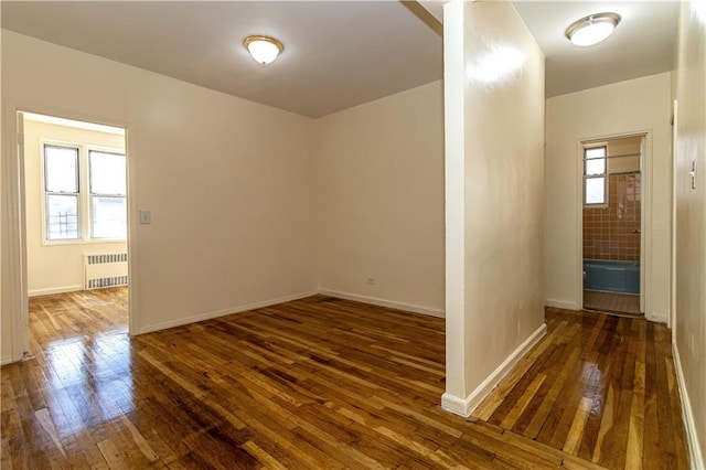 50 Kenilworth Pl Unit 5M, Brooklyn, NY 11210 - empty room with radiator heating unit and hardwood / wood-style flooring