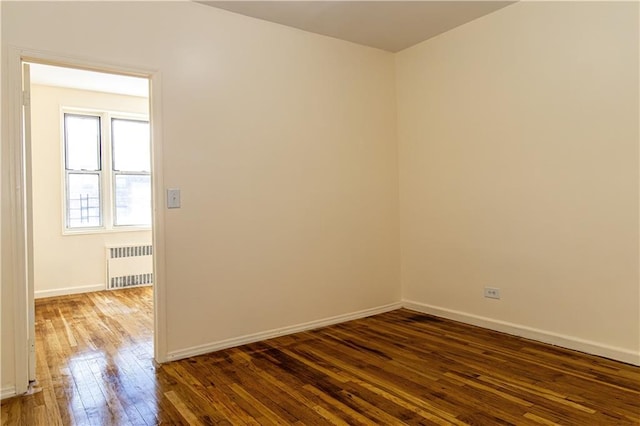 50 Kenilworth Pl Unit 5M, Brooklyn, NY 11210 - spare room featuring radiator heating unit and dark wood finished floors