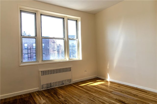 50 Kenilworth Pl Unit 5M, Brooklyn, NY 11210 - spare room with radiator and dark wood-style flooring
