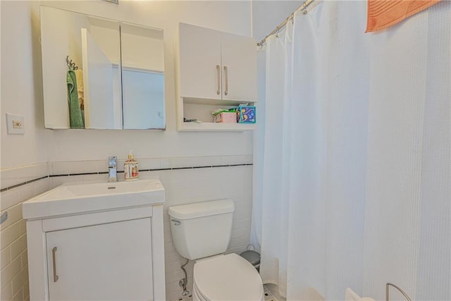 bathroom featuring tile walls, toilet, vanity, and a shower with curtain