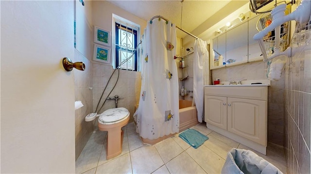 7401 Shore Rd Unit 6F, Brooklyn, NY 11209 - bathroom with tile patterned floors, tile walls, toilet, vanity, and shower / tub combo with curtain