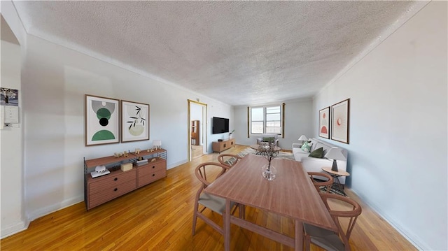 7401 Shore Rd Unit 6F, Brooklyn, NY 11209 - dining room with a textured ceiling, light wood-type flooring, and baseboards