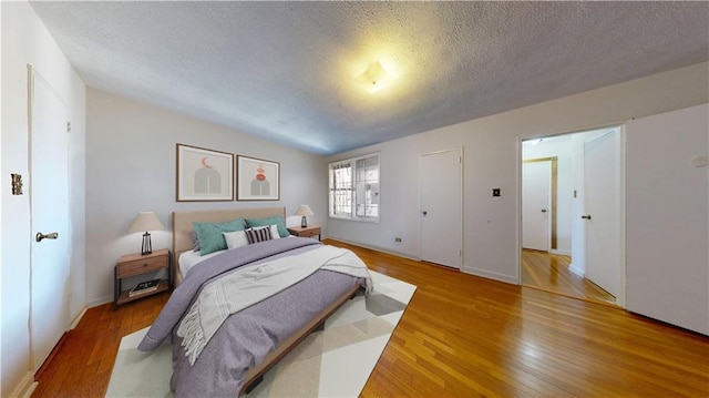7401 Shore Rd Unit 6F, Brooklyn, NY 11209 - bedroom with light wood finished floors, a textured ceiling, and baseboards