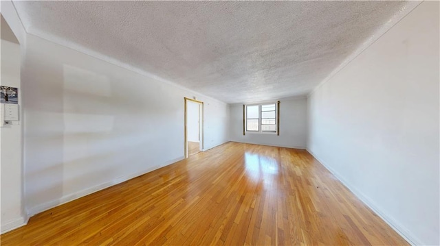 7401 Shore Rd Unit 6F, Brooklyn, NY 11209 - spare room featuring baseboards, a textured ceiling, and light wood finished floors