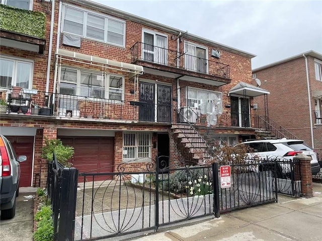 1931 85th St, Brooklyn, NY 11214 - view of property featuring brick siding, a fenced front yard, and a garage