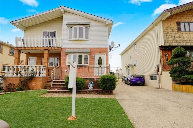 39 Longdale St, Staten Island, NY 10314 - view of front facade with driveway, a front yard, brick siding, and a porch