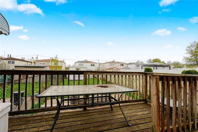 wooden deck with outdoor dining area and a residential view
