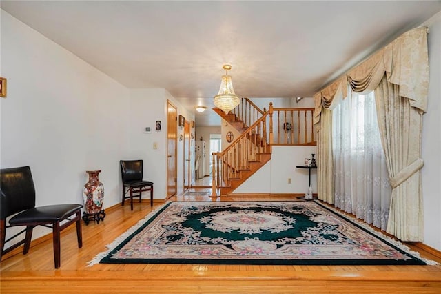 entrance foyer featuring stairway, baseboards, and wood finished floors