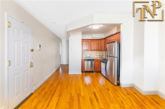 9526 Schenck St Unit 2, Brooklyn, NY 11236 - kitchen with stainless steel appliances, light wood-type flooring, light countertops, and baseboards