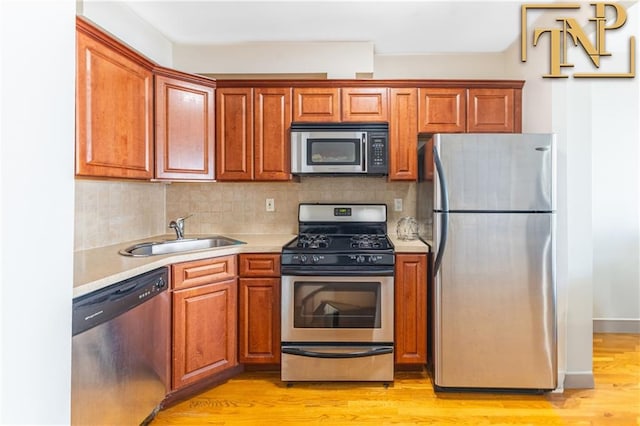 9526 Schenck St Unit 2, Brooklyn, NY 11236 - kitchen with appliances with stainless steel finishes, a sink, light countertops, and light wood finished floors