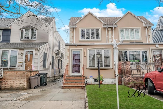 1859 E 34th St, Brooklyn, NY 11234 - view of front of property featuring stucco siding, a front lawn, and entry steps