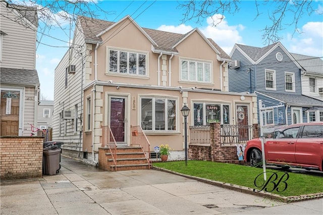 1859 E 34th St, Brooklyn, NY 11234 - view of front of house featuring stucco siding, entry steps, and a front yard