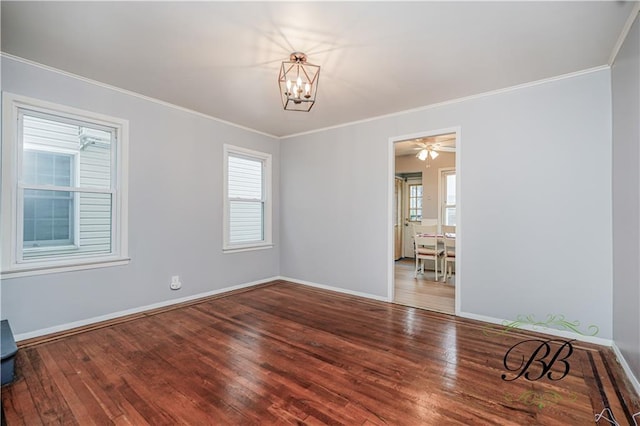 unfurnished room featuring wood-type flooring, baseboards, crown molding, and a wealth of natural light