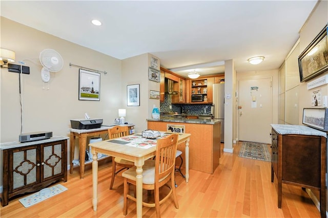 dining room with recessed lighting and light wood-style flooring