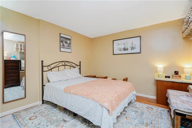 bedroom with light wood-style floors and baseboards