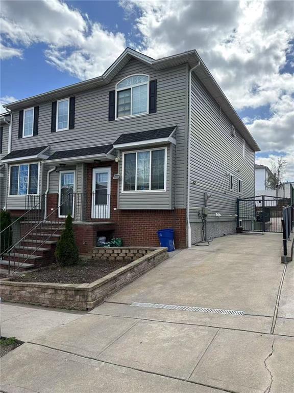 81 Burgundy Loop, Staten Island, NY 10304 - view of front of property featuring brick siding and a gate