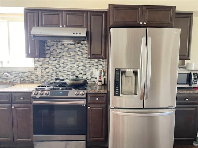 81 Burgundy Loop, Staten Island, NY 10304 - kitchen with dark brown cabinets, a sink, stainless steel appliances, tasteful backsplash, and under cabinet range hood