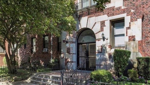 doorway to property featuring brick siding