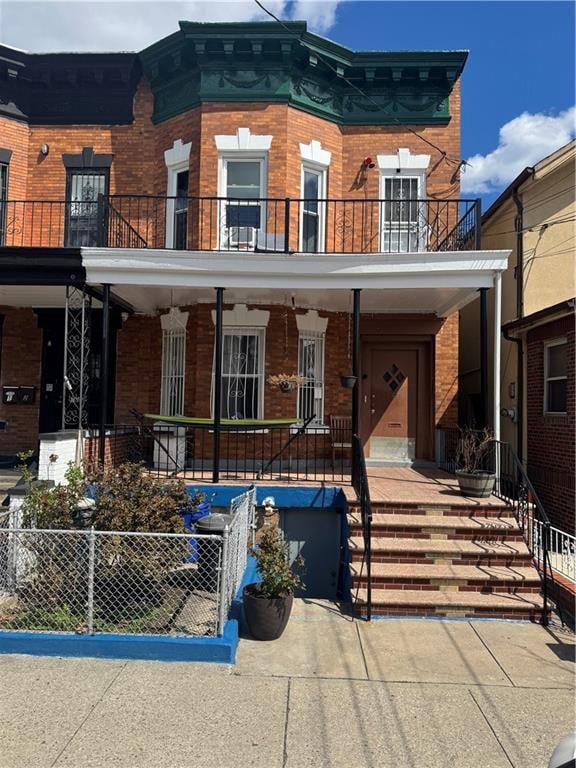 1689 E 48th St, Brooklyn, NY 11234 - townhome / multi-family property featuring brick siding, a porch, and a fenced front yard