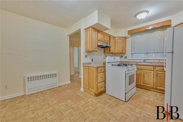 2076 E 63rd St, Brooklyn, NY 11234 - kitchen featuring white appliances, radiator heating unit, under cabinet range hood, baseboards, and light countertops
