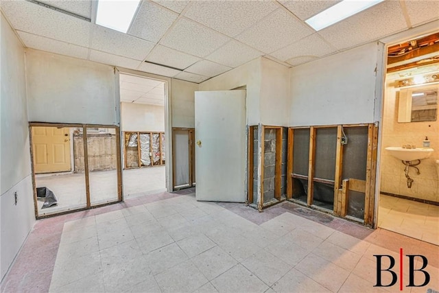 2076 E 63rd St, Brooklyn, NY 11234 - unfurnished room with a drop ceiling, a sink, and tile patterned floors