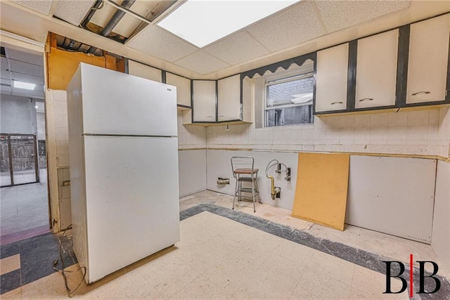 2076 E 63rd St, Brooklyn, NY 11234 - kitchen with freestanding refrigerator, light flooring, and a paneled ceiling