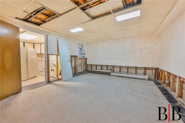 2076 E 63rd St, Brooklyn, NY 11234 - spare room with a baseboard radiator, a drop ceiling, tile patterned floors, and wainscoting