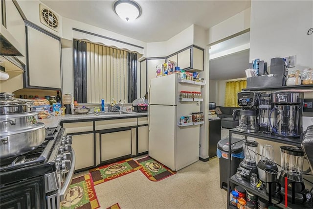 2076 E 63rd St, Brooklyn, NY 11234 - kitchen featuring freestanding refrigerator, a sink, gas stove, light countertops, and light floors