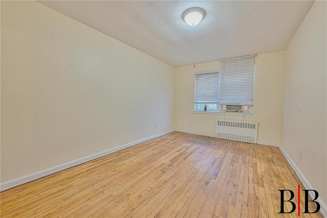 2076 E 63rd St, Brooklyn, NY 11234 - spare room with radiator heating unit, hardwood / wood-style flooring, and baseboards